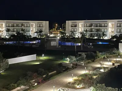 a view of a building at night with lights at LyriosHomes Luxury Costa Ballena Beach in Chipiona