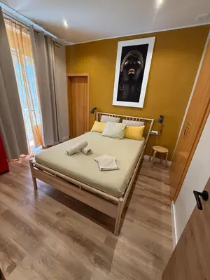 a bedroom with a bed with a picture on the wall at PRECIOUS AND ORIGINAL APARTMENT CENTER in Cádiz