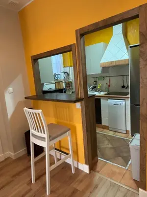 a small kitchen with a white chair and a counter at PRECIOUS AND ORIGINAL APARTMENT CENTER in Cádiz
