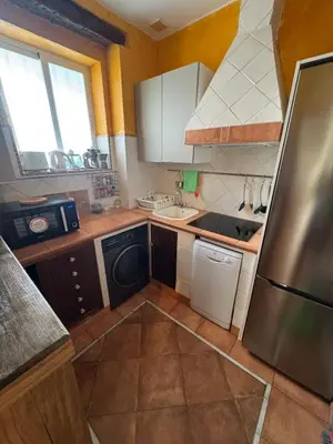 a small kitchen with a refrigerator and a dishwasher at PRECIOUS AND ORIGINAL APARTMENT CENTER in Cádiz