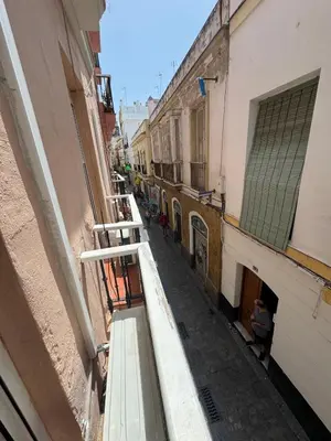 a view of an alley from a balcony of a building at PRECIOUS AND ORIGINAL APARTMENT CENTER in Cádiz