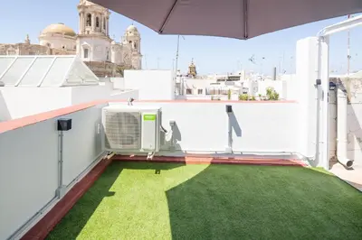 a balcony with a green lawn on a roof at La Terraza del Populo Little Apartments in Cádiz
