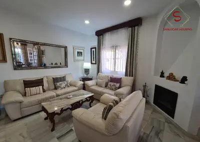 a living room with two couches and a fireplace at Casa Hermosilla con piscina by Sanlúcar Housing in Sanlúcar de Barrameda