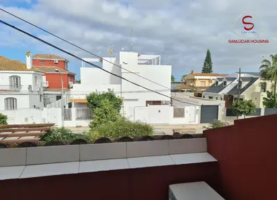 a view of a city from the roof of a building at Casa Hermosilla con piscina by Sanlúcar Housing in Sanlúcar de Barrameda