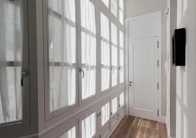 a hallway with windows and a door at Casa Mariana - Luxury Apartment - 4 Personas in Cádiz