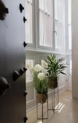 a room with two potted plants and a door at Casa Mariana - Luxury Apartment - 4 Personas in Cádiz