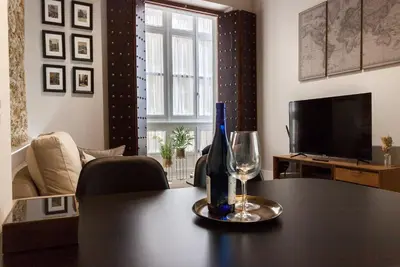 a living room with a table with a bottle and a wine glass at Casa Mariana - Luxury Apartment - 4 Personas in Cádiz