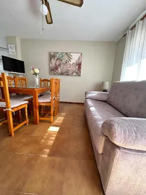 a living room with a couch and a table at Dúplex Playa Sol Ostra in Chiclana de la Frontera