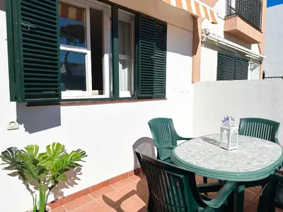a green table and chairs on a patio at Dúplex Playa Sol Ostra in Chiclana de la Frontera