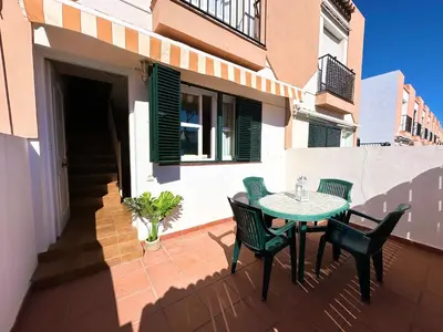 a patio with a table and chairs on a balcony at Dúplex Playa Sol Ostra in Chiclana de la Frontera