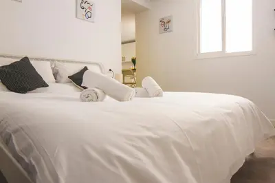 a white bed with white sheets and pillows at CDZ - Botica in Cádiz
