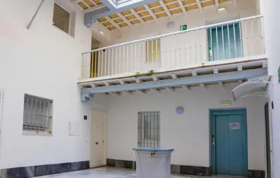 a room with a staircase and a blue door at CDZ - Botica in Cádiz