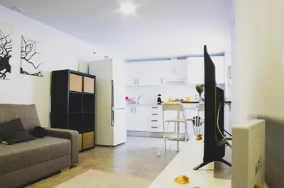a living room with a couch and a kitchen at CDZ - Botica in Cádiz
