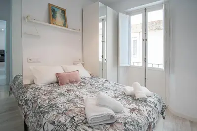 a bedroom with a bed with towels on it at Apartamento Las Lectoras de Cadiz in Cádiz