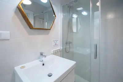 a bathroom with a sink and a shower with a mirror at Apartamento Las Lectoras de Cadiz in Cádiz