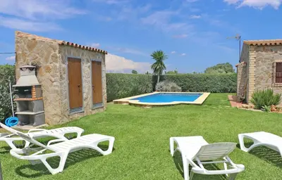 a backyard with a pool and chairs and a house at Chalet Piedra in Conil de la Frontera