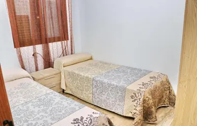 a room with two beds and a window at Chalet Piedra in Conil de la Frontera