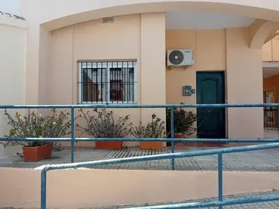 a building with a gate and a door at Apartamento Marina de la bahía in Puerto Real