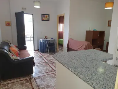 a kitchen and a living room with a counter top at Apartamento Marina de la bahía in Puerto Real