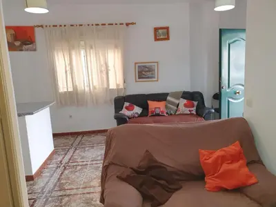 a living room with a couch with pillows on it at Apartamento Marina de la bahía in Puerto Real
