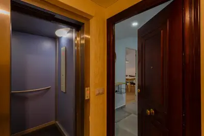 a hallway with a blue door next to a room at MAREAS Family Home by Cadiz4Rentals in Cádiz