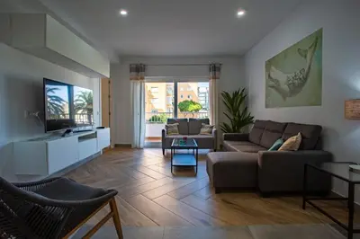 a living room with a couch and a tv at MAREAS Family Home by Cadiz4Rentals in Cádiz