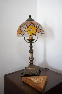 a lamp on a wooden table with a glass lamp on it at Valdelagrana Sunset Apartment in El Puerto de Santa María