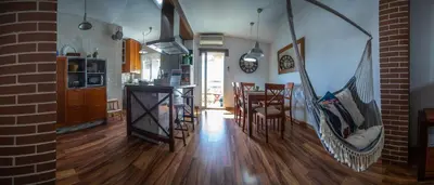 a kitchen and dining room with a hammock in a house at Valdelagrana Sunset Apartment in El Puerto de Santa María