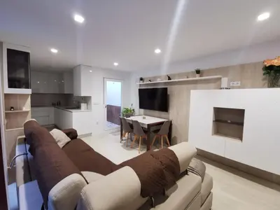 a living room with a couch and a dining room at Casa Viento de Levante in Cádiz