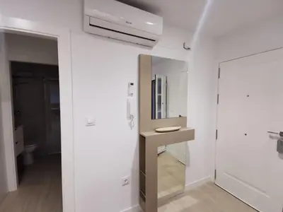 a white bathroom with a sink and a mirror at Casa Viento de Levante in Cádiz