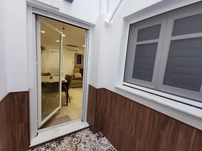 a balcony with a window and a living room at Casa Viento de Levante in Cádiz
