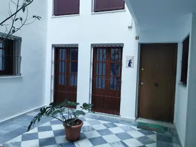 a house with three doors and a checkered floor at Casa Viento de Levante in Cádiz