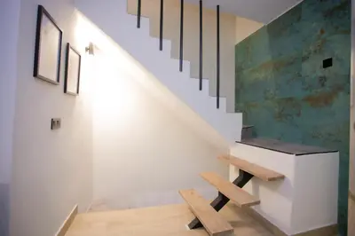 a staircase in a house with a bench underneath it at Azahara Casa Boutique in Arcos de la Frontera