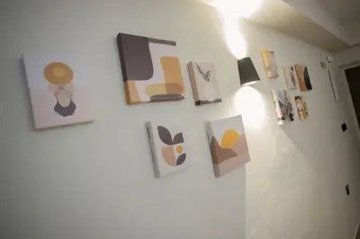 a wall with paintings and pictures on it at Azahara Casa Boutique in Arcos de la Frontera