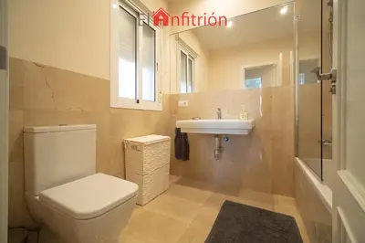 a bathroom with a toilet and a sink at Araucaria Home in Sanlúcar de Barrameda