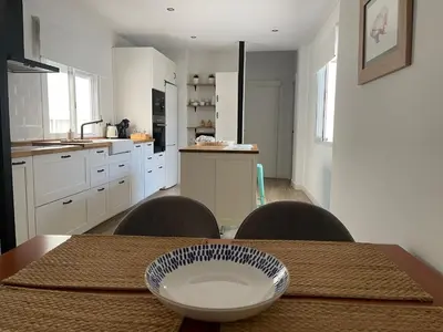 a kitchen with a table with a bowl on top of it at Apartamentos La Higuera 1 in Rota