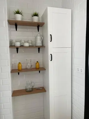 a kitchen with shelves with dishes and vases on them at Apartamentos La Higuera 1 in Rota