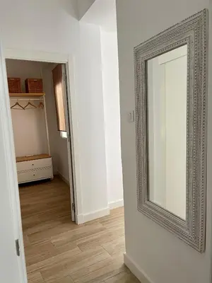 an empty room with a mirror on the wall at Apartamentos La Higuera 1 in Rota