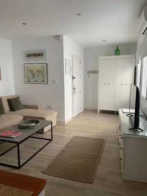 a living room with a couch and a table at Apartamentos La Higuera 1 in Rota