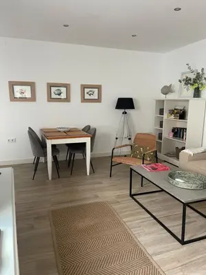 a living room with a table and a couch at Apartamentos La Higuera 1 in Rota