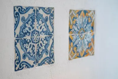 two blue and white tiles on a wall at Bodega Mar - Velo de Flor in Sanlúcar de Barrameda