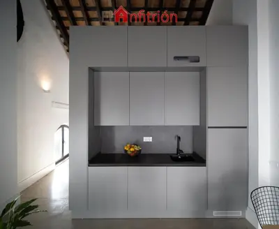 a kitchen with white cabinets and a sink at Bodega Mar - Velo de Flor in Sanlúcar de Barrameda