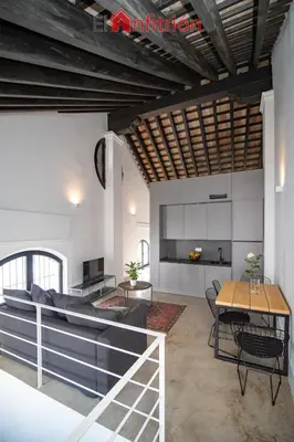 a living room with a table and a couch at Bodega Mar - Velo de Flor in Sanlúcar de Barrameda