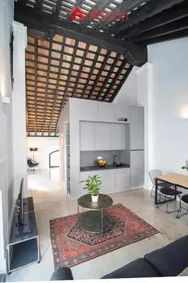 a living room with a table and a dining room at Bodega Mar - Velo de Flor in Sanlúcar de Barrameda