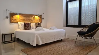 a bedroom with a bed with two towels on it at Bodega Mar - Solera in Sanlúcar de Barrameda