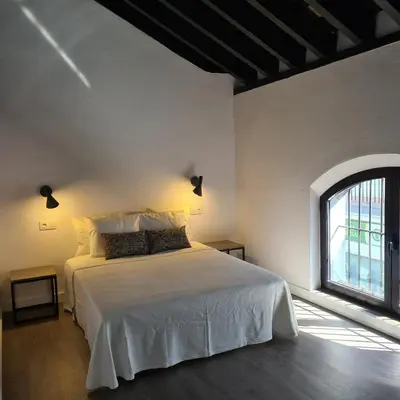 a bedroom with a white bed and a window at Bodega Mar - Solera in Sanlúcar de Barrameda