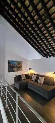 a living room with a couch and a fence at Bodega Mar - Solera in Sanlúcar de Barrameda