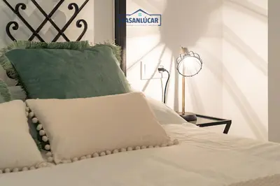 a laptop computer sitting on top of a bed at Apartamento Diego Benitez in Sanlúcar de Barrameda