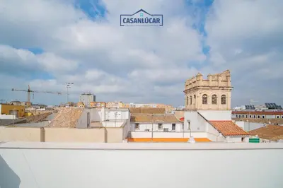 a view of a city from the roof of a building at Apartamento Diego Benitez in Sanlúcar de Barrameda