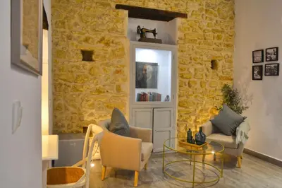 a living room with two chairs and a glass table at Alojamientos Plaza de España in Medina Sidonia